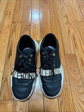 Valentino Black and White Leather Sneakers with Gold Logo Strap